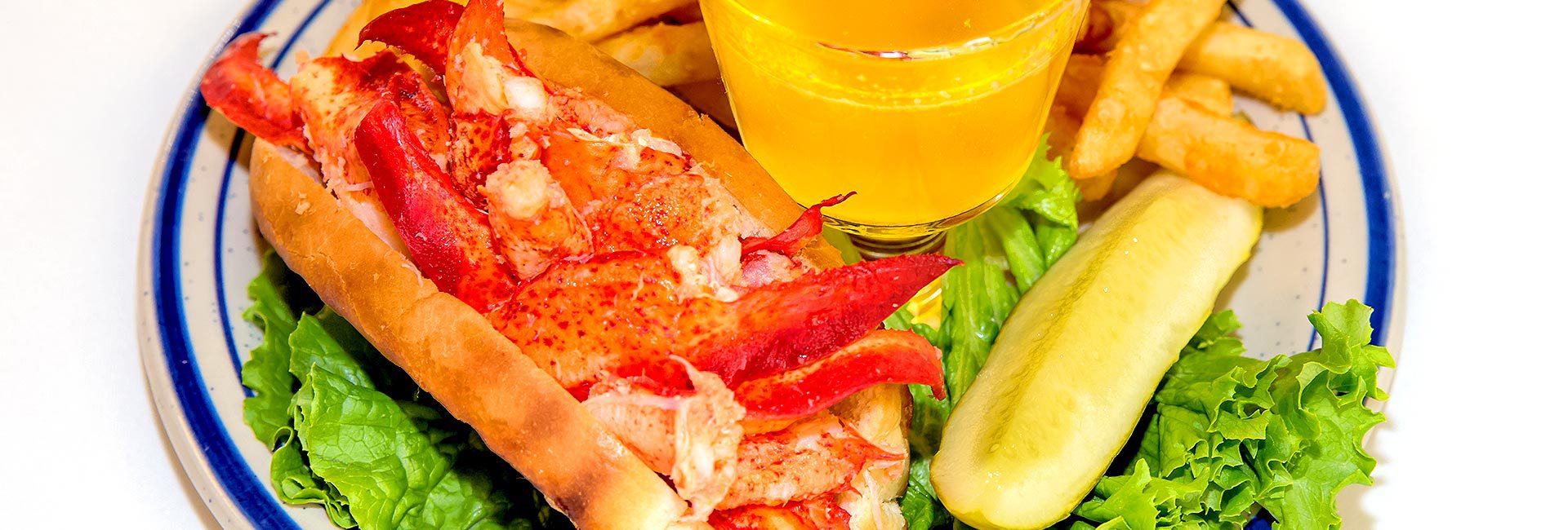 Rudee's shrimp po boy sandwish with pickle and fries